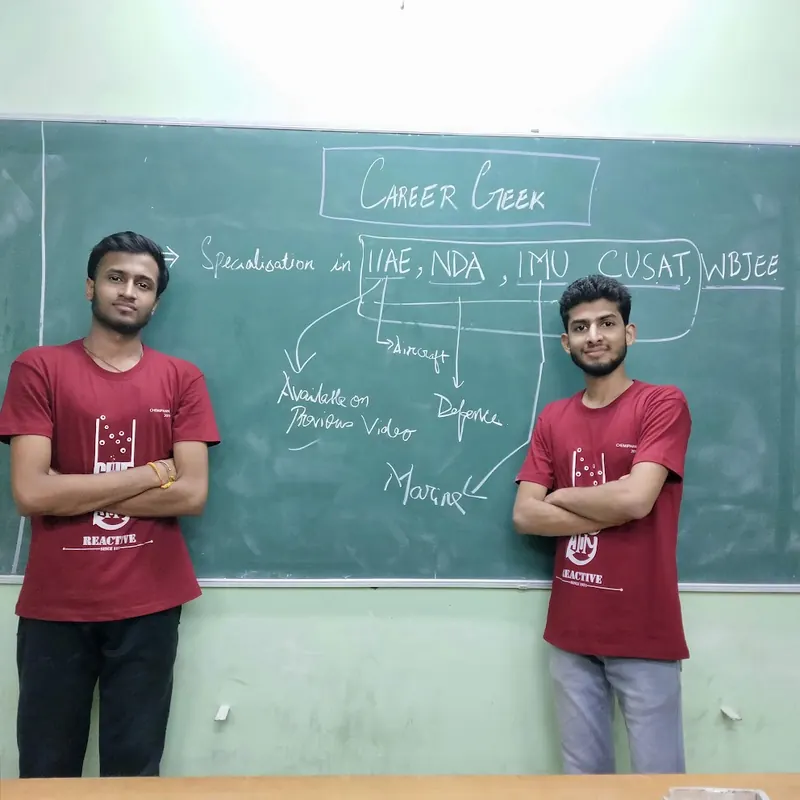 Bunny Goyal and his co-founder beside a Career Geek blackboard